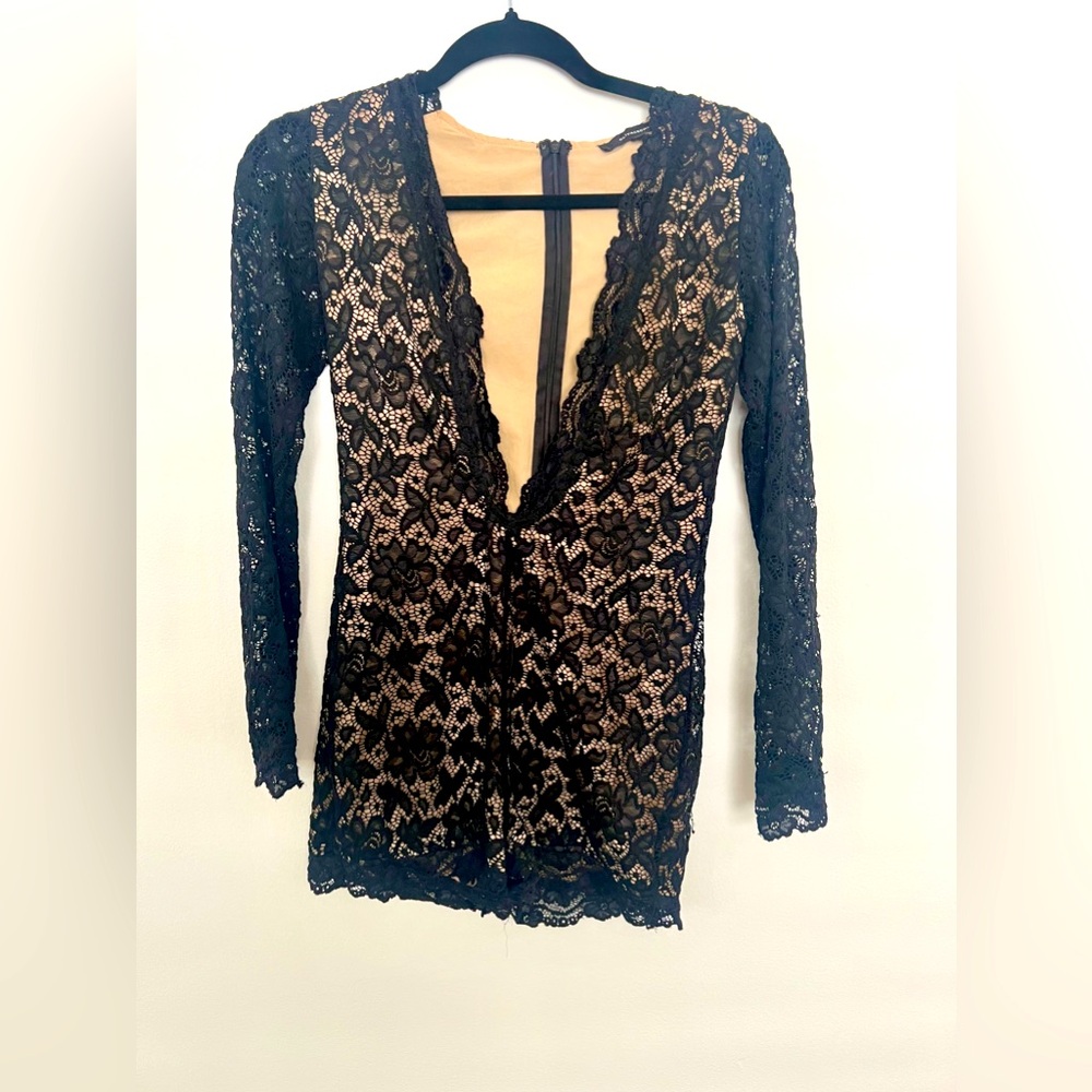 Black lace romper, tight and low cut.